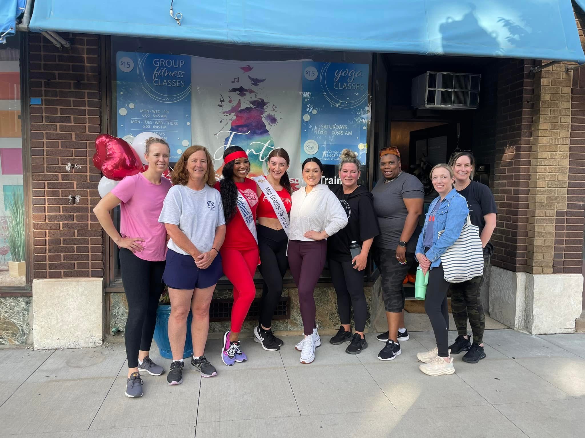 Members with pageant winner at storefront